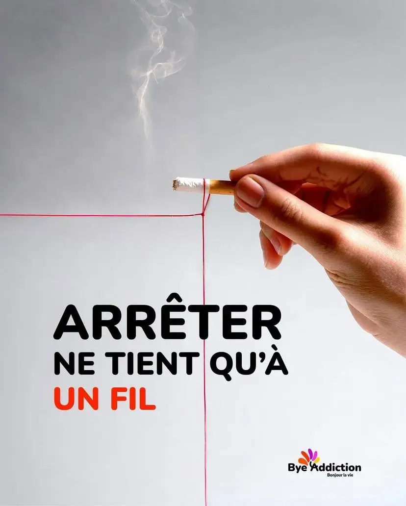 Main tenant une cigarette coupée par un fil rouge illustrant l’arrêt du tabac et la dépendance